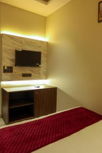 a room with a flat screen tv on a wall at Jaipur Qila - A Boutique Hotel and Rooftop Cafe in Jaipur