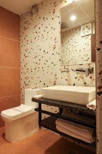 a bathroom with a sink and a toilet and a mirror at Jaipur Qila - A Boutique Hotel and Rooftop Cafe in Jaipur +145 photos
