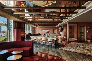 a living room with a large table and chairs at 25hours Hotel Dubai One Central in Dubai