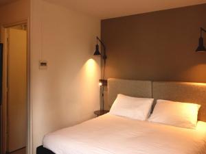 Postel nebo postele na pokoji v ubytování ibis Lille Centre Grand Place
