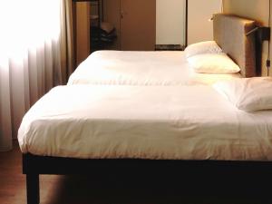 Postel nebo postele na pokoji v ubytování ibis Lille Centre Grand Place