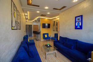 a living room with a blue couch and a table at casa chaouen in Chefchaouen