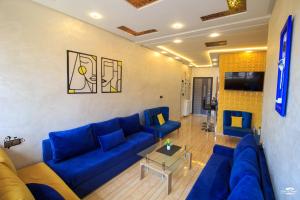 a living room with a blue couch and a table at casa chaouen in Chefchaouene