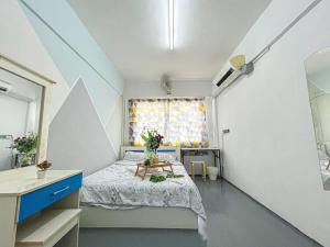 a bedroom with a bed and a sink and a window at Cheras, 1-10pax, FREE WIFI, 3BR in Cheras