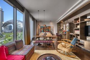 a living room with a couch and a table at 25hours Hotel Dubai One Central in Dubai