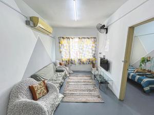 a living room with two couches and a television at Cheras, 1-10pax, FREE WIFI, 3BR in Cheras