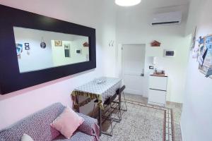 a living room with a table and a mirror on the wall at Vasto House in Vasto