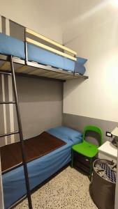a bedroom with a bunk bed and a green chair at Vasto House in Vasto