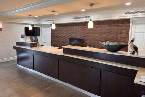 a lobby with a counter with a bowl of fruit at Wingate by Wyndham Galveston Beachfront at the Seawall in Galveston