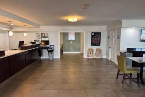 a large kitchen and dining room with tables and chairs at Wingate by Wyndham Galveston Beachfront at the Seawall in Galveston