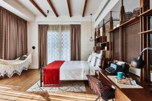 a hotel room with a bed and a desk at 25hours Hotel Dubai One Central in Dubai
