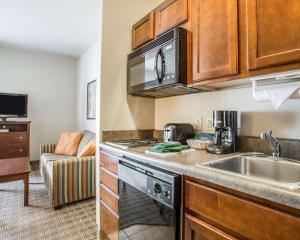 a kitchen with a sink and a microwave at MainStay Suites St Robert - Fort Leonard Wood in Saint Robert