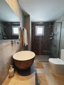 a bathroom with a large tub and a toilet at 3 Br Penthouse Jacuzzi Seaview in Limassol +9 photos
