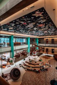 a large building with a mural on the ceiling at 25hours Hotel Dubai One Central in Dubai