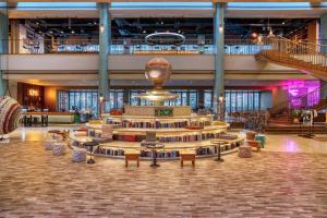 a library with tables and chairs in a building at 25hours Hotel Dubai One Central in Dubai