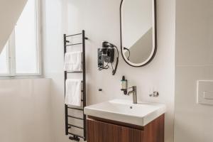 a bathroom with a sink and a mirror at Esplanade Carlsbad in Karlovy Vary