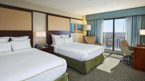 a hotel room with two beds and a window at DoubleTree by Hilton Orlando Theme Park Resort in Orlando