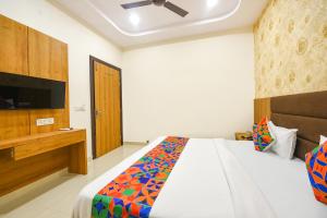 a bedroom with a bed and a flat screen tv at FabHotel Golden Tree in Amritsar