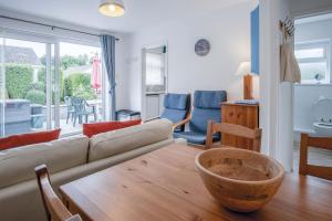 a living room with a couch and a table at Bayview 61 - 2 Bedroom Chalet - Bayview Oxwich in Oxwich