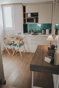 a kitchen with a table and chairs in a room at GeoFan Penthouse I in Athens