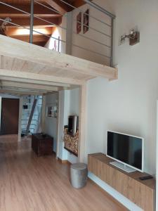 a living room with a flat screen tv on a wall at Loft Open Space Adele -Tirano Centro Storico in Tirano