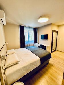 a hotel room with a bed and a desk at Hotel Avalon Kyustendil in Kyustendil +32 photos