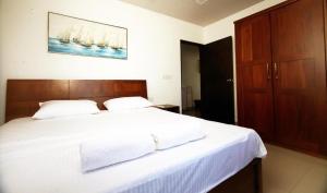 Ένα ή περισσότερα κρεβάτια σε δωμάτιο στο A1 Apartments at Ocean Breeze Residency +5 φωτογραφίες