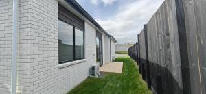 an empty alley between two buildings with windows at Contemporary New 2-Bedroom Home in Hamilton