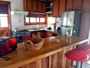 a kitchen with a wooden counter with a counter top at Vistas del Cerro San Antonio in Piriápolis