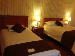Postel nebo postele na pokoji v ubytování Villa Emilia Hostal