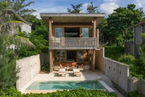 a house with a pool and a balcony at Six Senses Con Dao - Turtle Island Paradise in Con Dao +37 photos