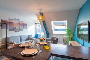 a dining room with a wooden table and a dining room at Le Saint-Patern - T3 centre-ville et garage sécurisé in Vannes