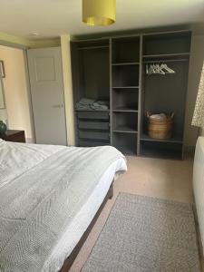 a bedroom with a bed and a closet at Cottage Retreat- Sleeps 4 Garden in Sherborne