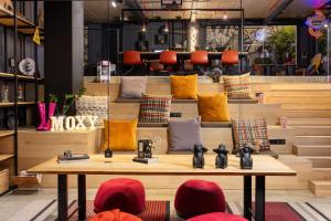 a store with a lot of pillows on a table at Moxy Lisbon City in Lisbon