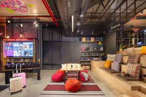 a store with colorful pillows and a table and a tv at Moxy Lisbon City in Lisbon +108 photos