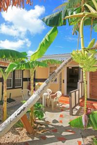 een patio met stoelen en een palmboom bij Mary's Boon Beach Plantation Resort & Spa in Simpson Bay