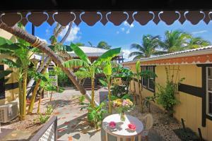 a patio with a table with flowers on it at Mary's Boon Beach Plantation Resort & Spa in Simpson Bay