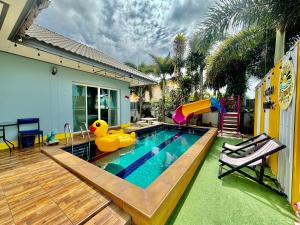 a swimming pool with a rubber duck in a backyard at Dream pool villa 2 in Ban Nong Chap Tao