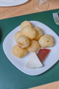 a plate of pastries on a green table at Hotel Lieto in Poços de Caldas