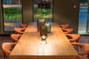a wooden table with vases on top of it at Motel One Hamburg Airport in Hamburg
