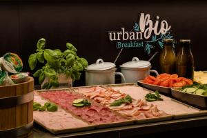 a table topped with different types of meat and vegetables at Motel One Hamburg Airport in Hamburg