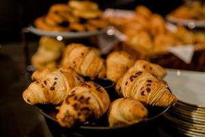 a bunch of pastries in a bowl on a table at Motel One Hamburg Airport in Hamburg