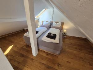 a bedroom with a bed in a room with stairs at Dachkoje Monschau in Monschau