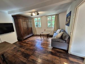 a living room with a couch and a table at Dachkoje Monschau in Monschau