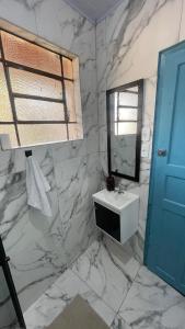 a marble bathroom with a sink and a mirror at Casa Jabuticabeira in Ouro Preto +29 photos
