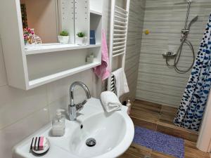 a bathroom with a sink and a shower at Elato apartment in Florina +25 photos