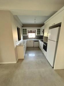 una grande cucina con elettrodomestici bianchi e una finestra di Villa Hisar a Seferihisar