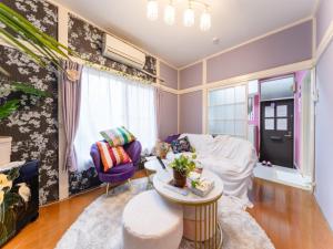 a living room with a couch and a table at Shinjuku, 3min walk from Nishi-Shinjuku 5-chome Sta, 3min Shinjuku Sta Switch, Wi-Fi ,Pocketwi-Fi in Tokyo