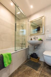 a bathroom with a sink and a glass shower at Fantastic Views Augsburg Center Luxury Congress in Augsburg +4 photos