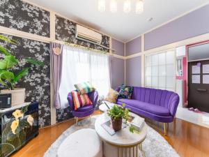 a living room with purple furniture and a purple couch at Shinjuku, 3min walk from Nishi-Shinjuku 5-chome Sta, 3min Shinjuku Sta Switch, Wi-Fi ,Pocketwi-Fi in Tokyo
